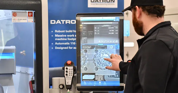 cnc programmer fulfilling his job description on a touch screen