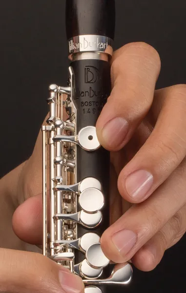 Closeup of someone holding a clarinet